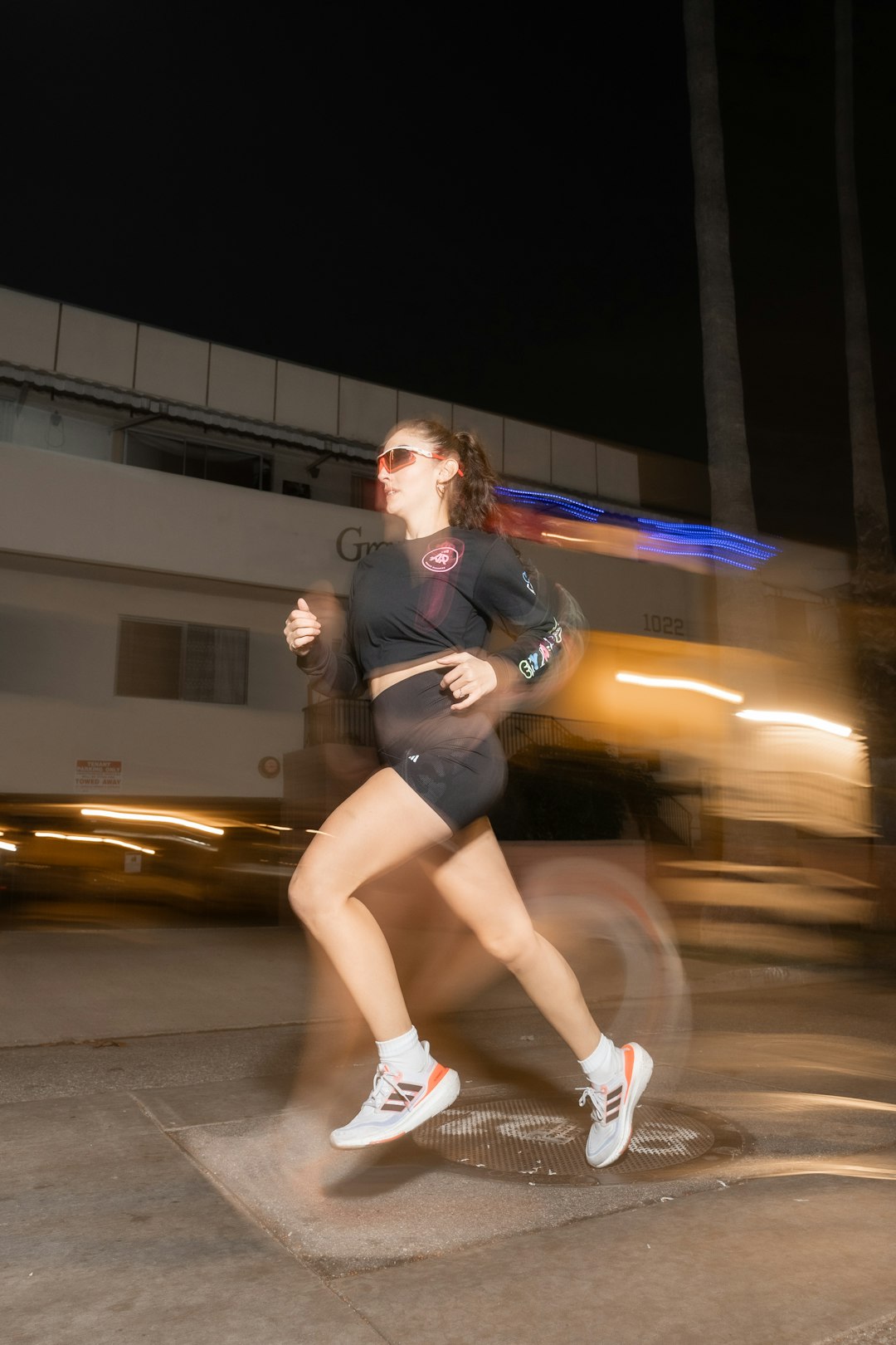 gallery-02 a-woman-running-on-a-city-street-at-night-ayd1demssju